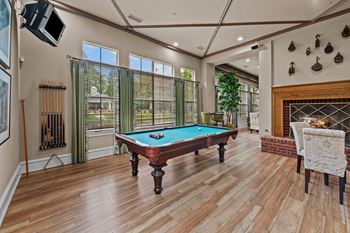 a pool table in a living room with a fireplace